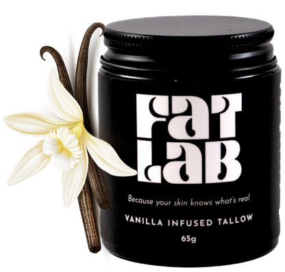Black jar of vanilla-infused tallow with vanilla flower and pod on a white background